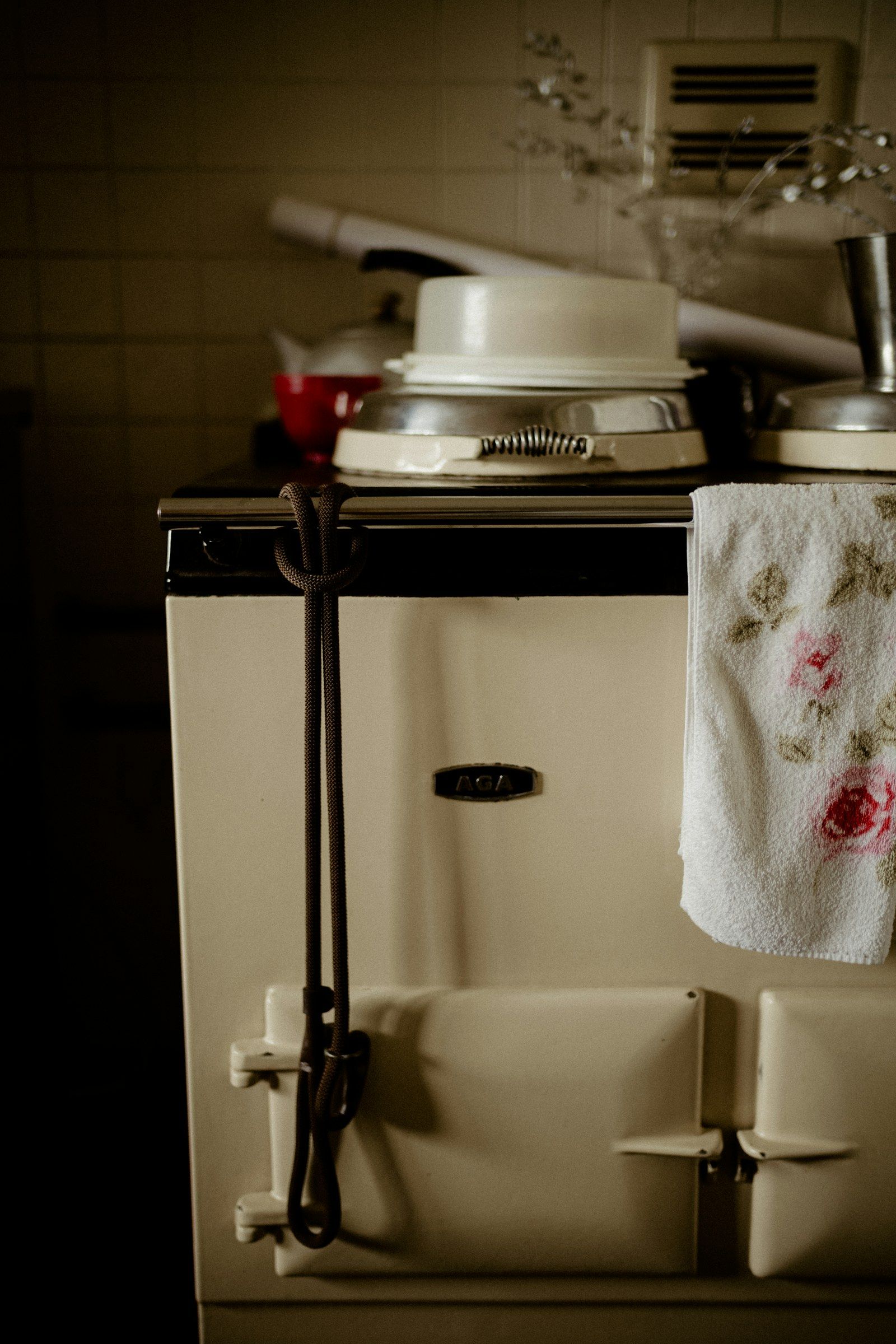 A cream AGA with a tea towel hanging from its rail