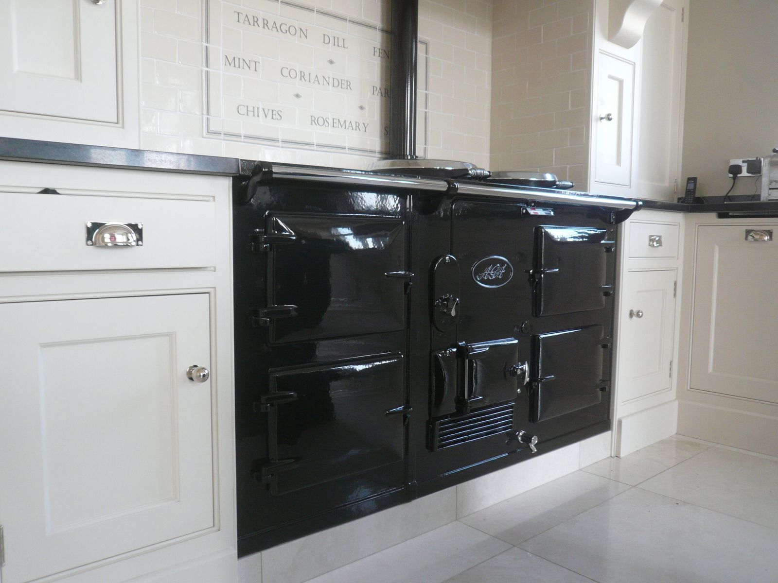 A black four-oven AGA fitted in a cream kitchen